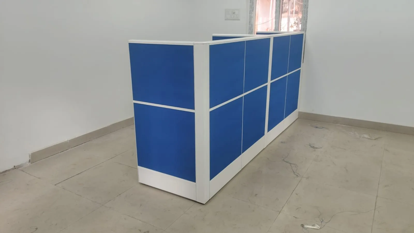Free-standing partition and counter run in the matching blue and white panel system